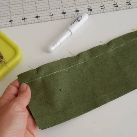 Two fabric pieces pinned together before sewing the seam