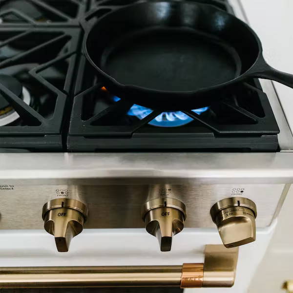 Cast iron pan on gas range with burner on