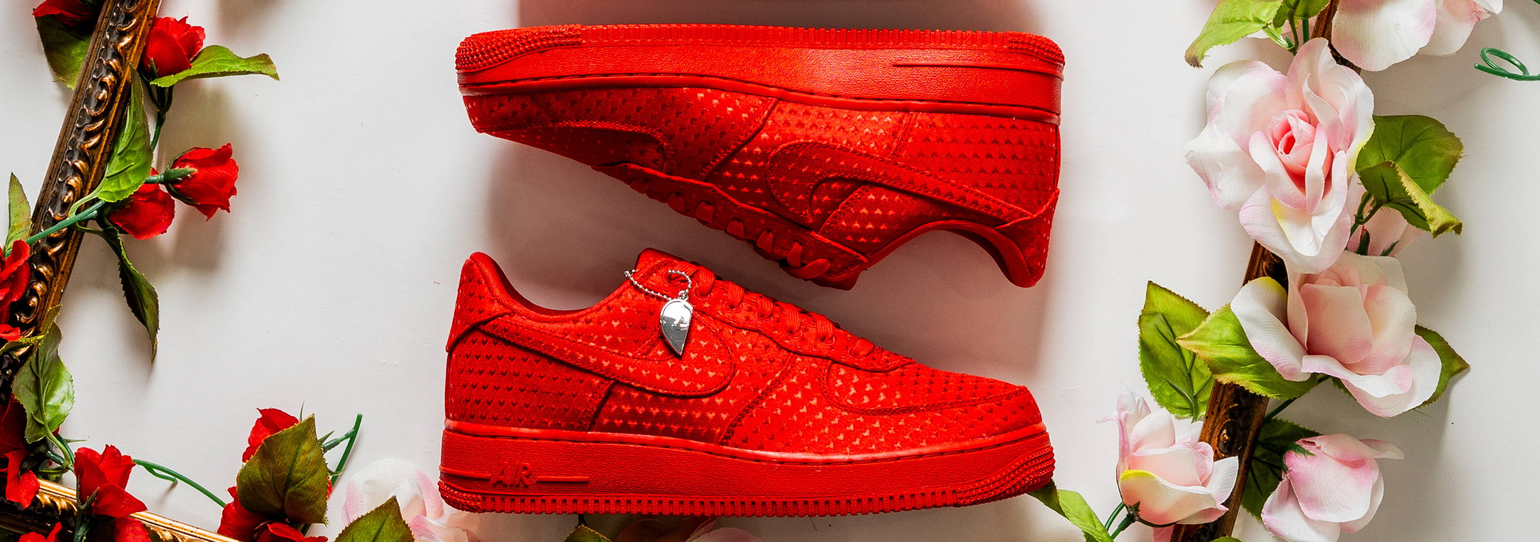 Red sneakers arranged in a floral frame.