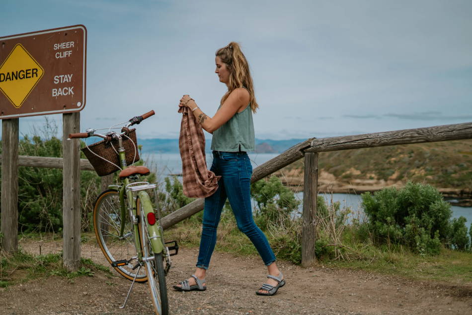 woman wearing adventure sandals on her bicycle