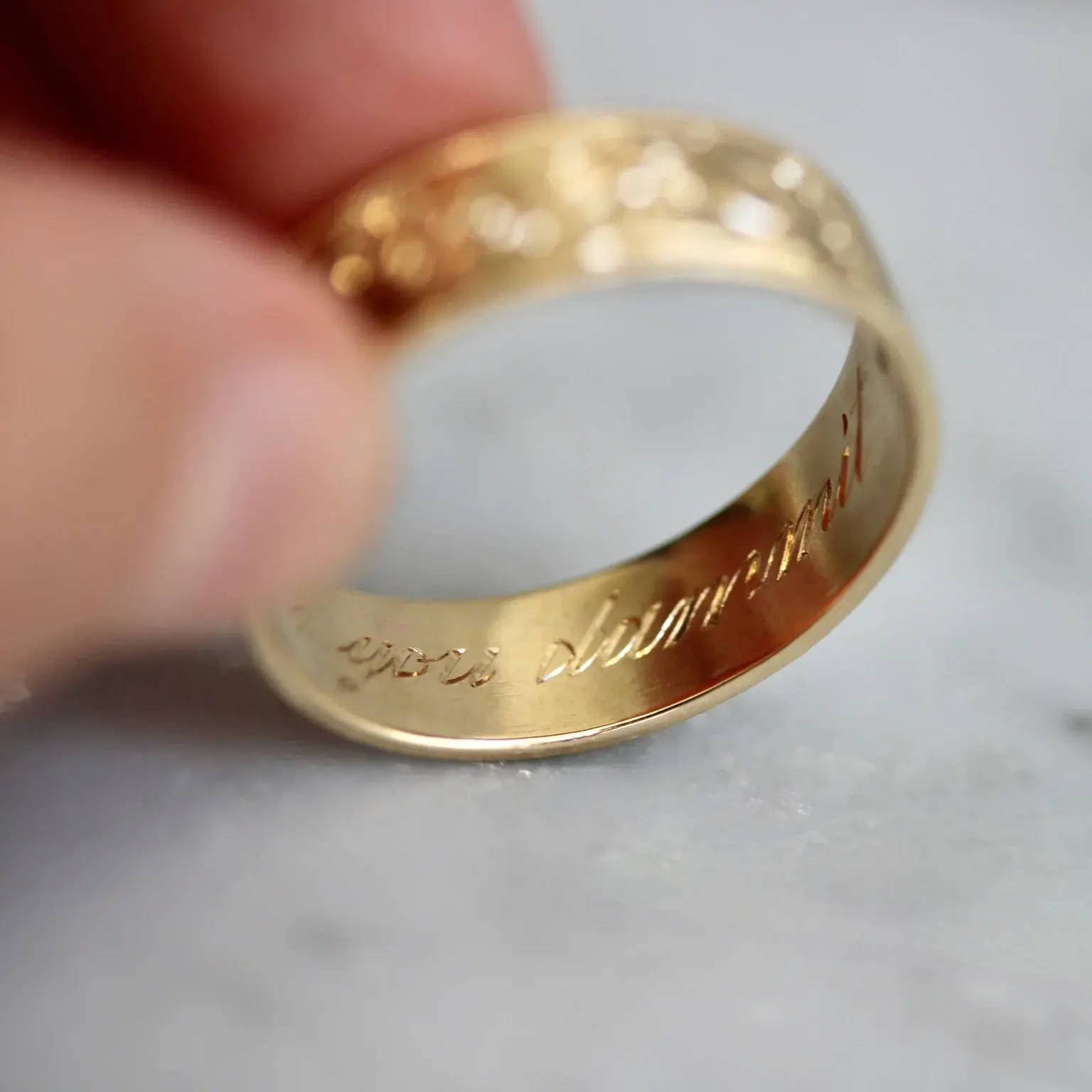 Hand-engraved-wedding-band-words-on-inside-of-band