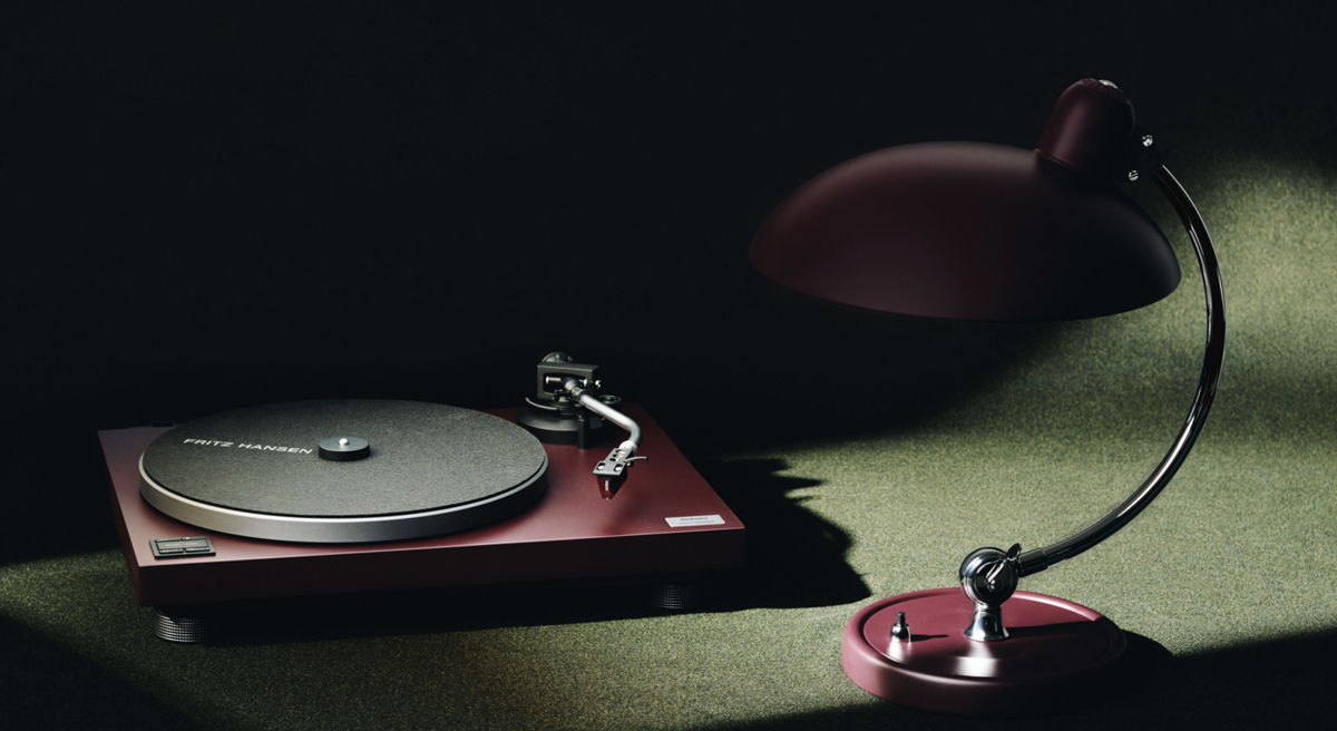 Turntable and lamp on a table in low light.