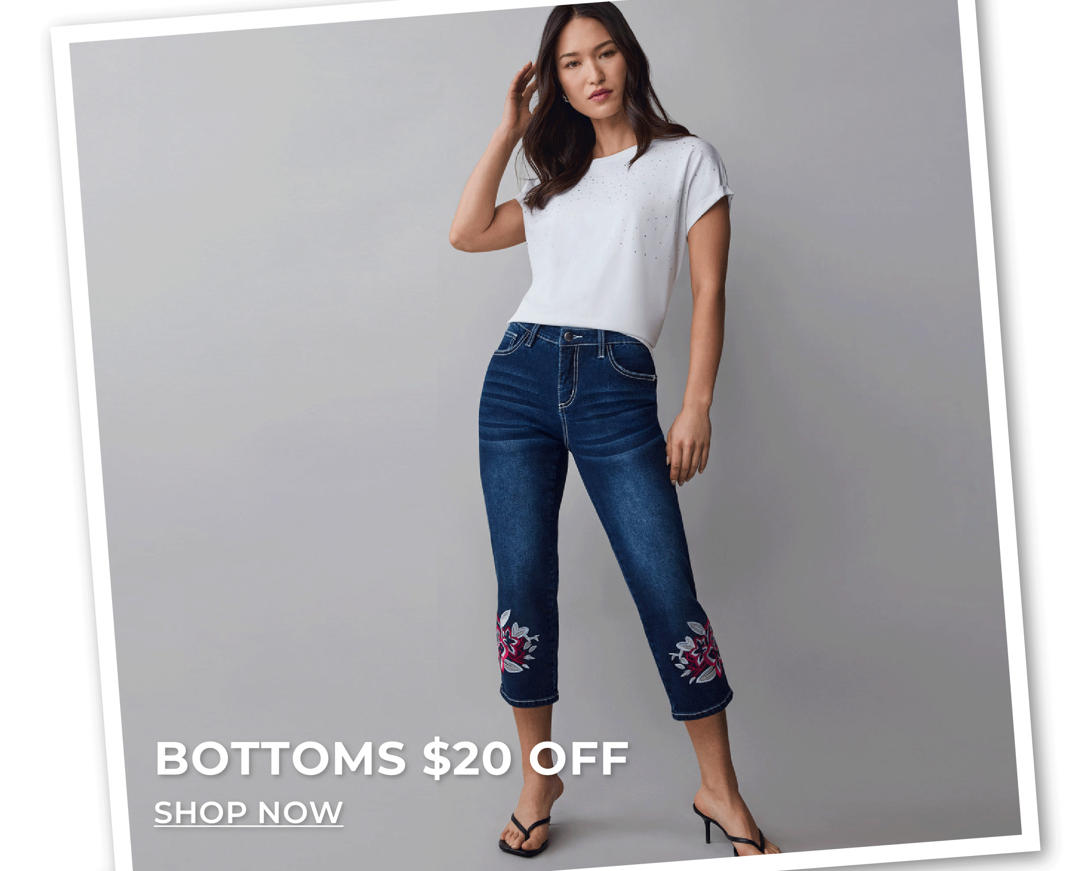 Woman standing in floral embroidered capris. Bottoms $20 off.