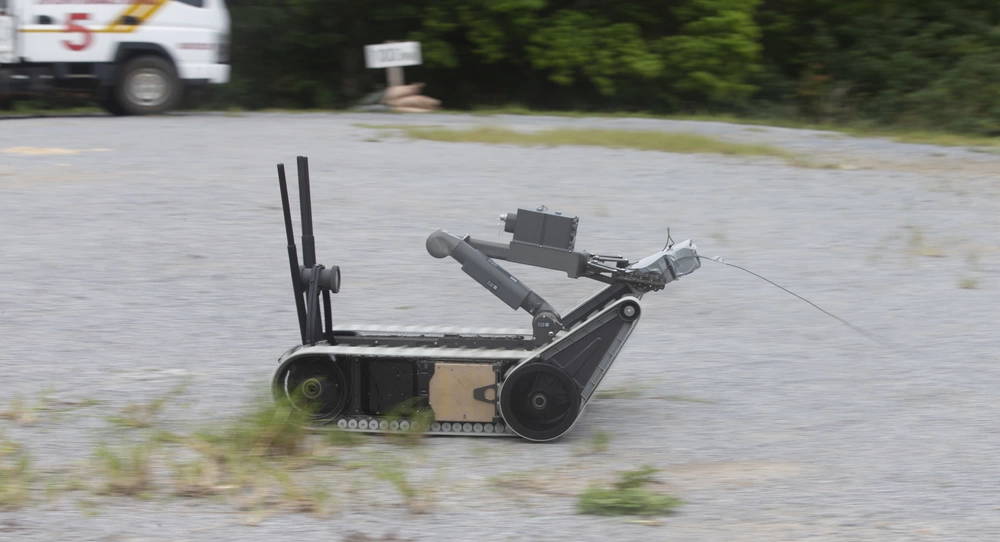 U.S. Marine Corps Sgt. Joshua Upright, an explosive ordnance disposal (EOD) technician with 3rd Maintenance Battalion, 3rd Marine Logistics Group, operates an XM1216 Small Unmanned Ground Vehicle during a demolition range on Camp Hansen, Okinawa, Japan, Aug. 18, 2021. EOD technicians conducted a demolition range to increase proficiency in using nonstandard demolition techniques including drop-charge detonations, time-fuse setups and a robotics platform to remotely emplace charges. (U.S. Marine Corps photo by Lance Cpl. Alex Fairchild)