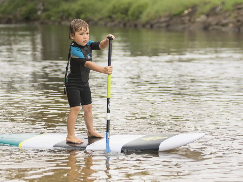 toddler on a paddle board