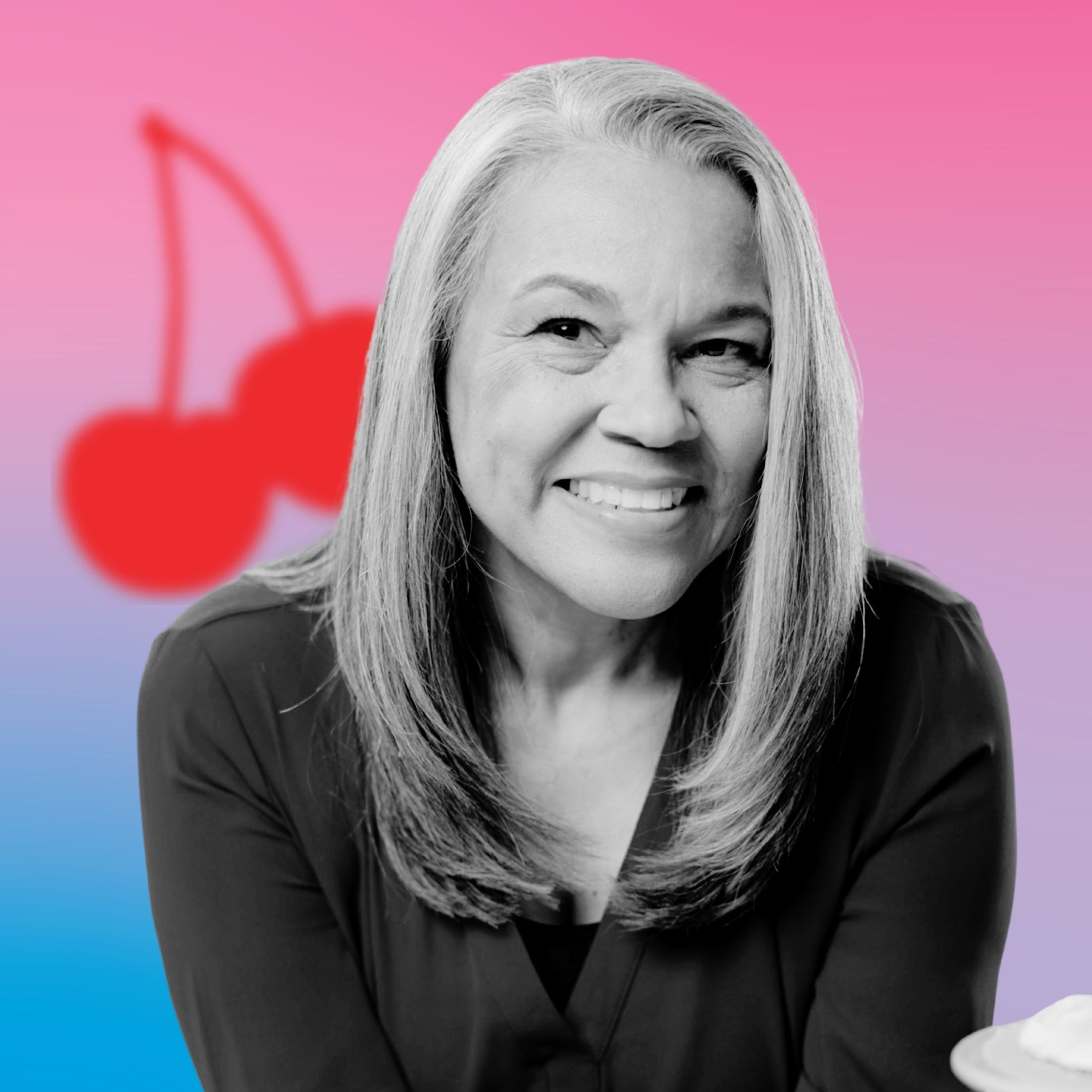 Smiling woman with long hair against a colorful background with cherries.