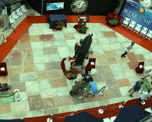 a group of people sitting in a room with a large screen