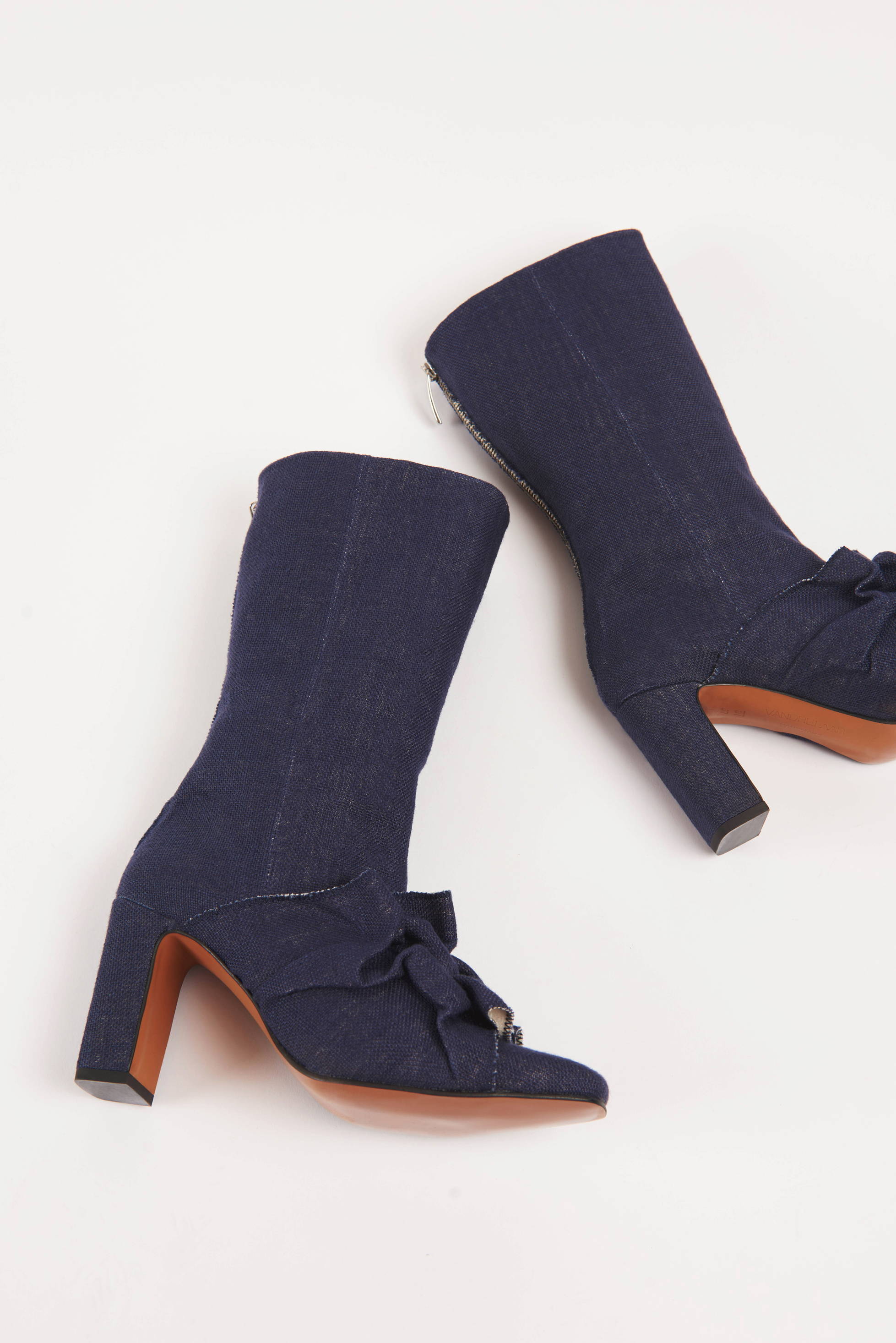 Pair of Vandrelaar Greta navy linen high-heel ankle boots, made from sustainable vegan materials and featuring brown sole