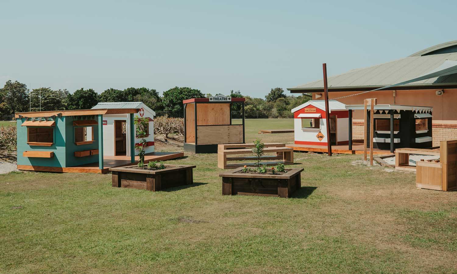 An overview image of play based learning village with several cubby houses