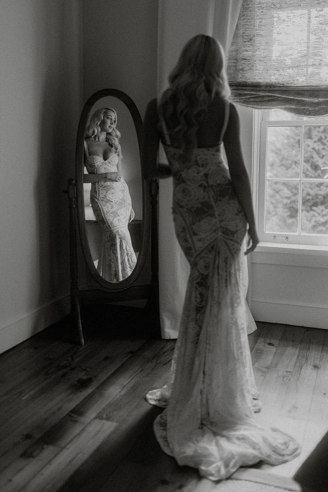 Bride in Grace Loves Lace Palm Gown standing in front of mirror