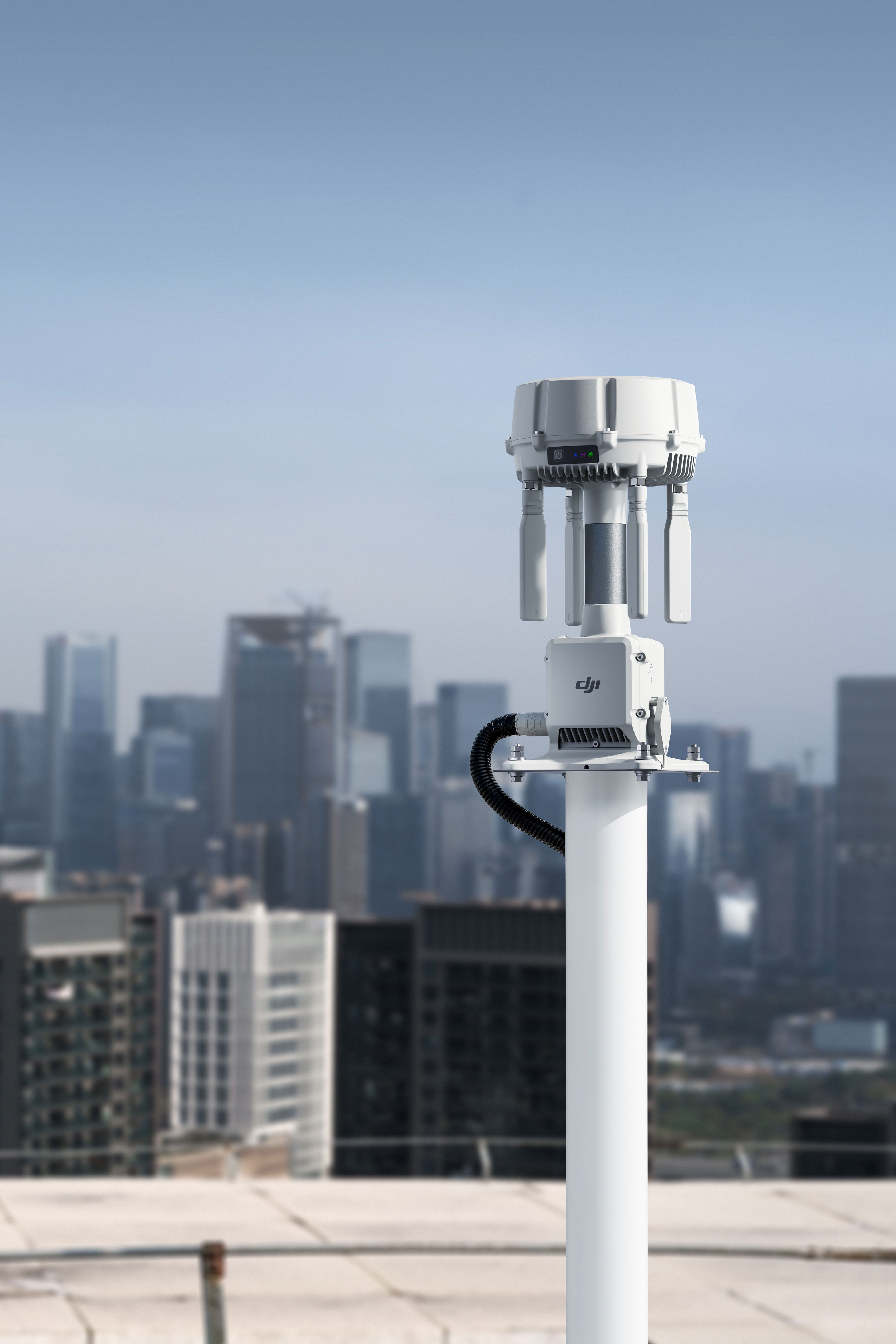 A DJI O4 Ground Station on a rooftop overlooking a city skyline.