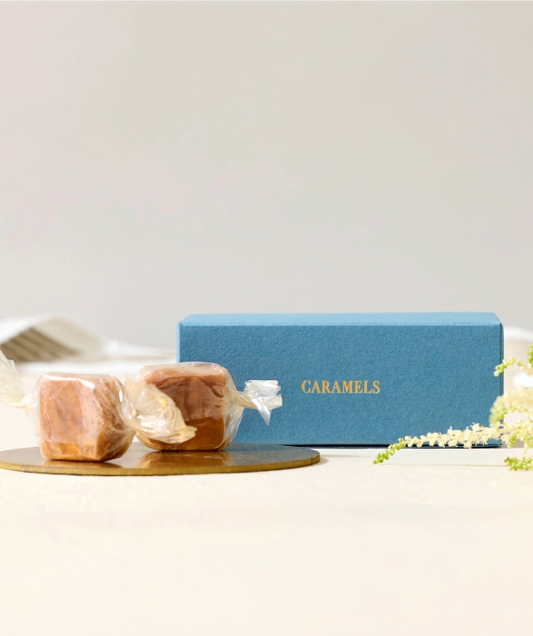 Two sweets beside a blue box labeled 