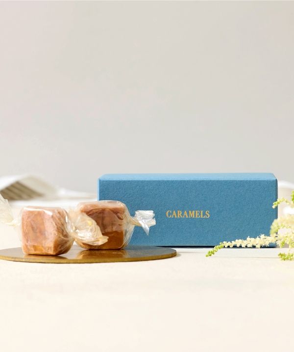 Two sweets beside a blue box labeled 