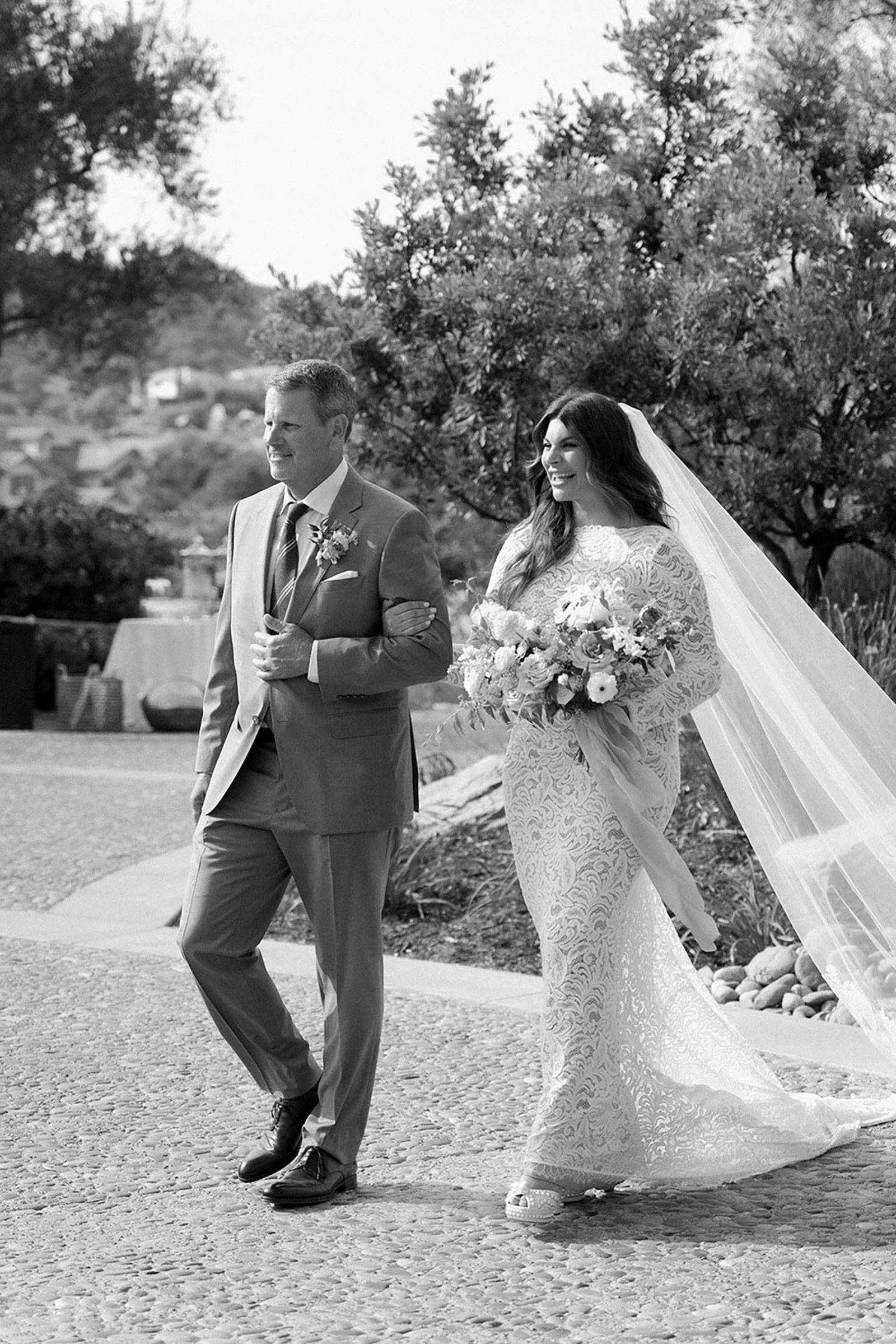 Bride walking down the aisle with family member