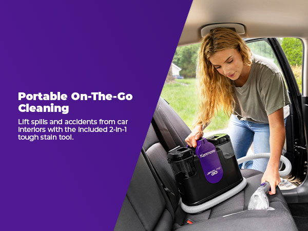 Woman using a portable spot cleaner in a car interior for cleaning.