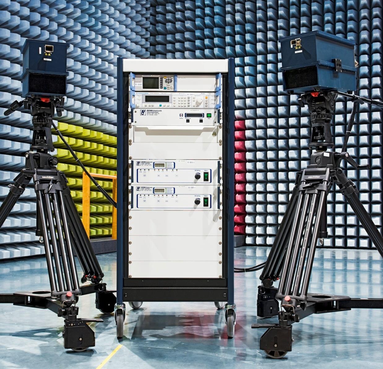 Equipment setup with cameras and a rack in a testing environment.