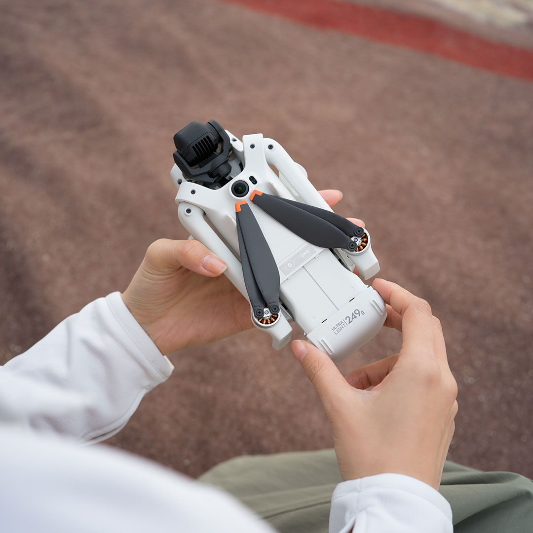 A person inserts a battery into the DJI Lito 1