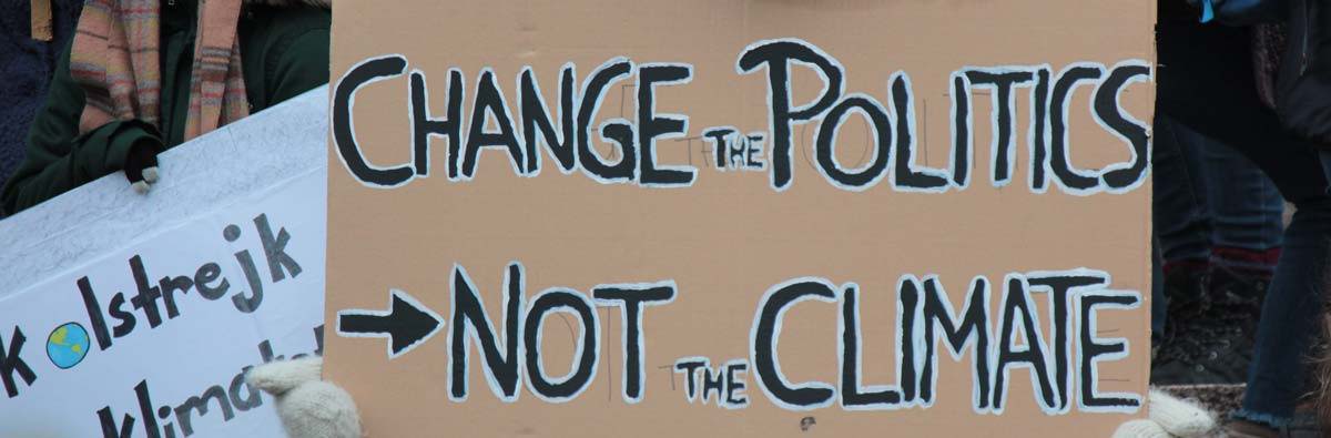 Change the Politics, Not the Climate protest sign