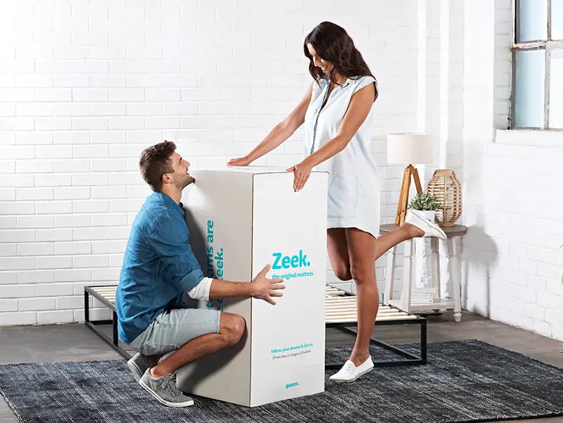A man and a woman displaying a Zeek delivery box.