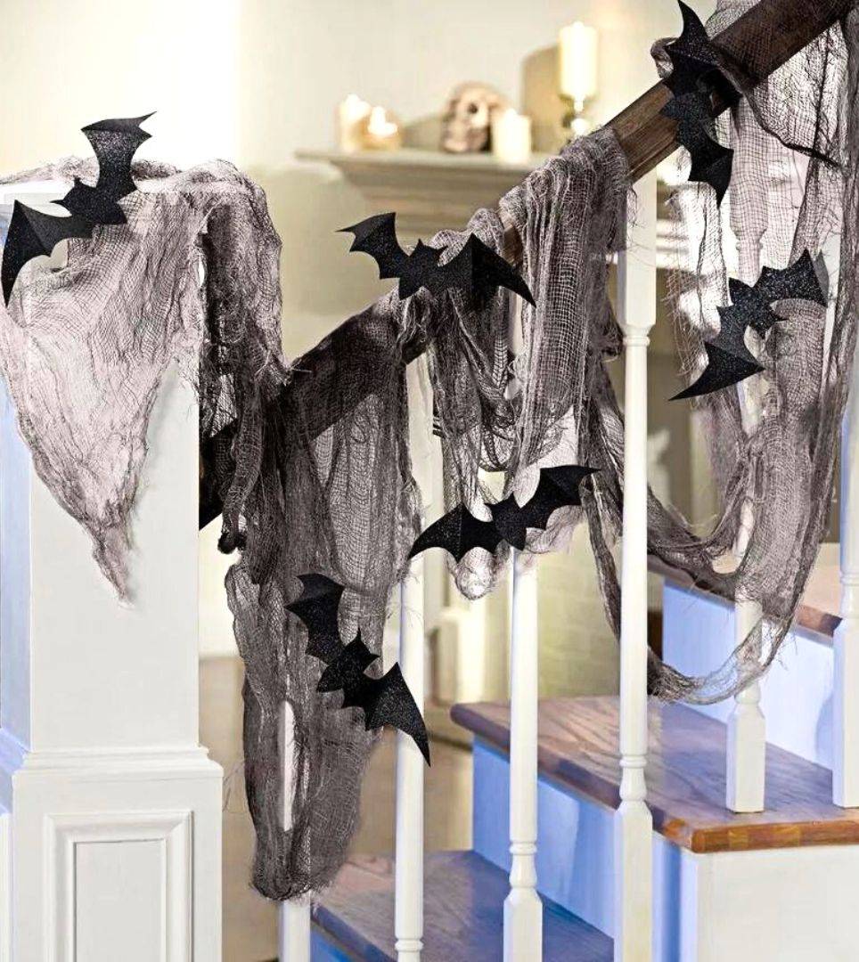 Bat cutouts arranged on staircase. Shop all creepy crawlies and critters for Halloween decor.