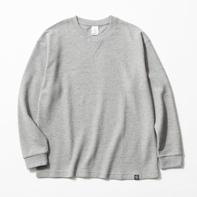 Gray long-sleeve waffle knit shirt on a white background.