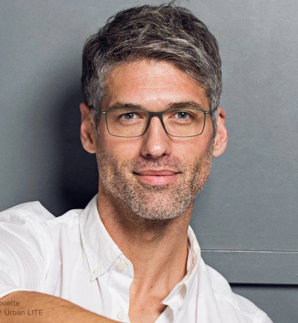 Man with grey hair wearing rectangle glasses