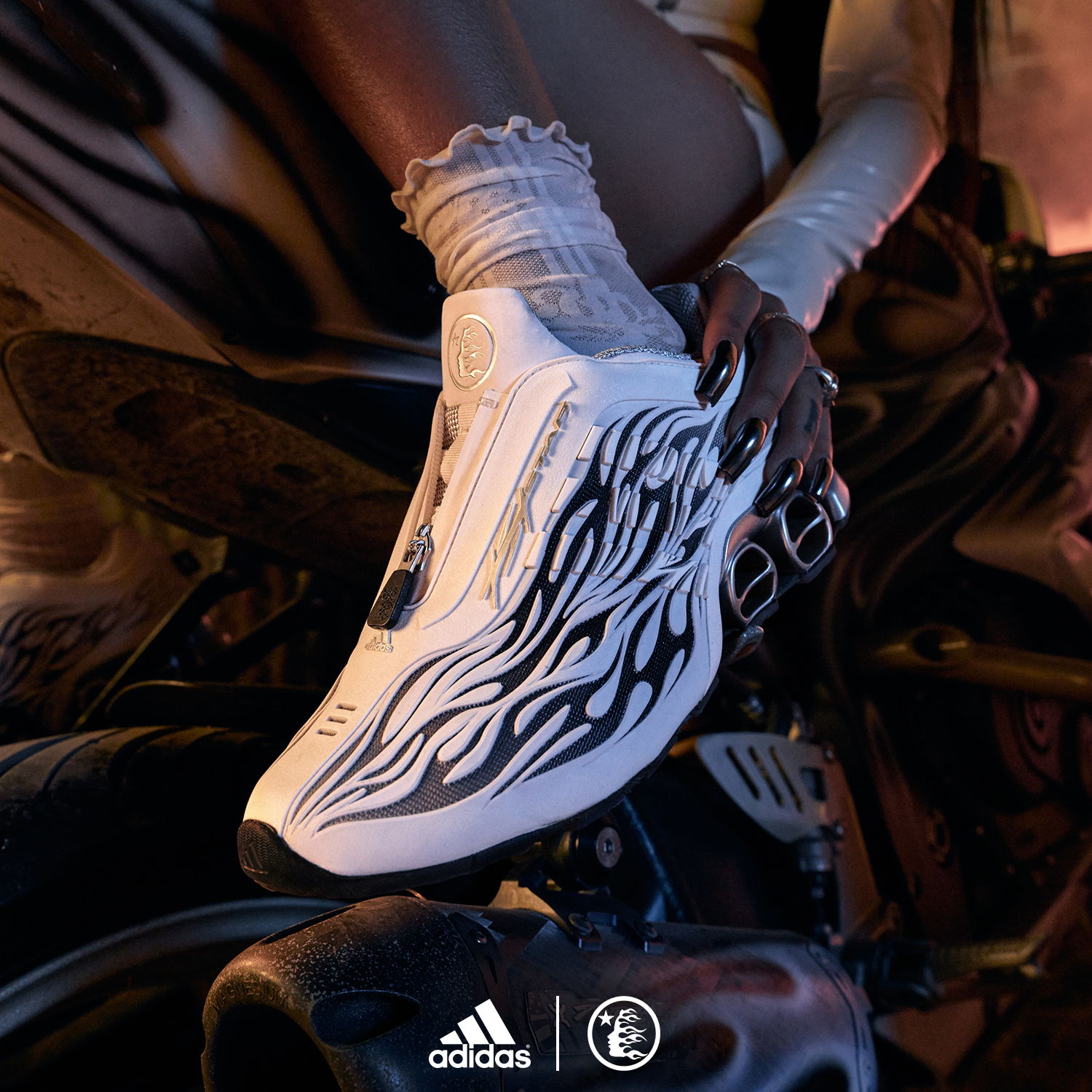 A close-up of stylish white sneakers with flame design.