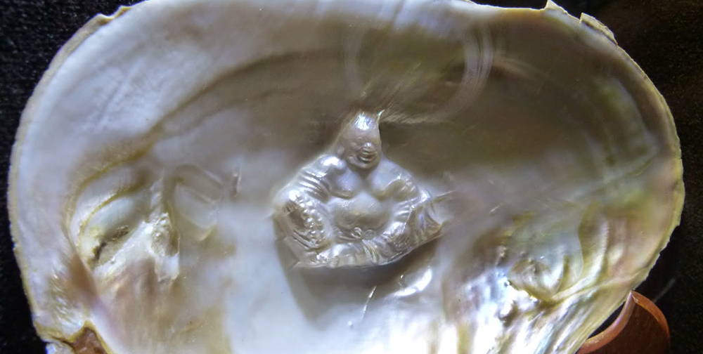 A small sculpture of Buddha Freshwater Cultured Pearl