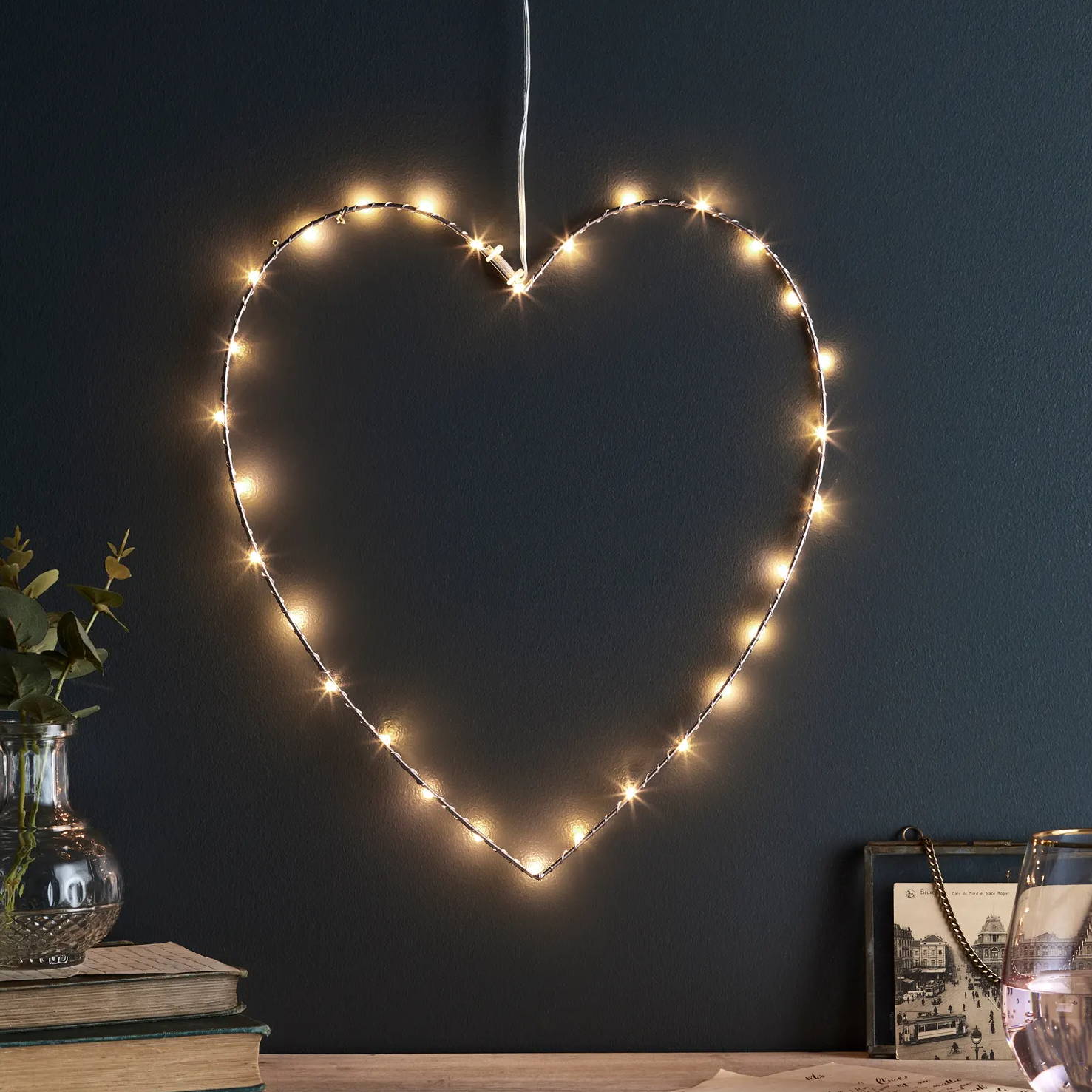 Rose gold fairy light heart illuminated on wall