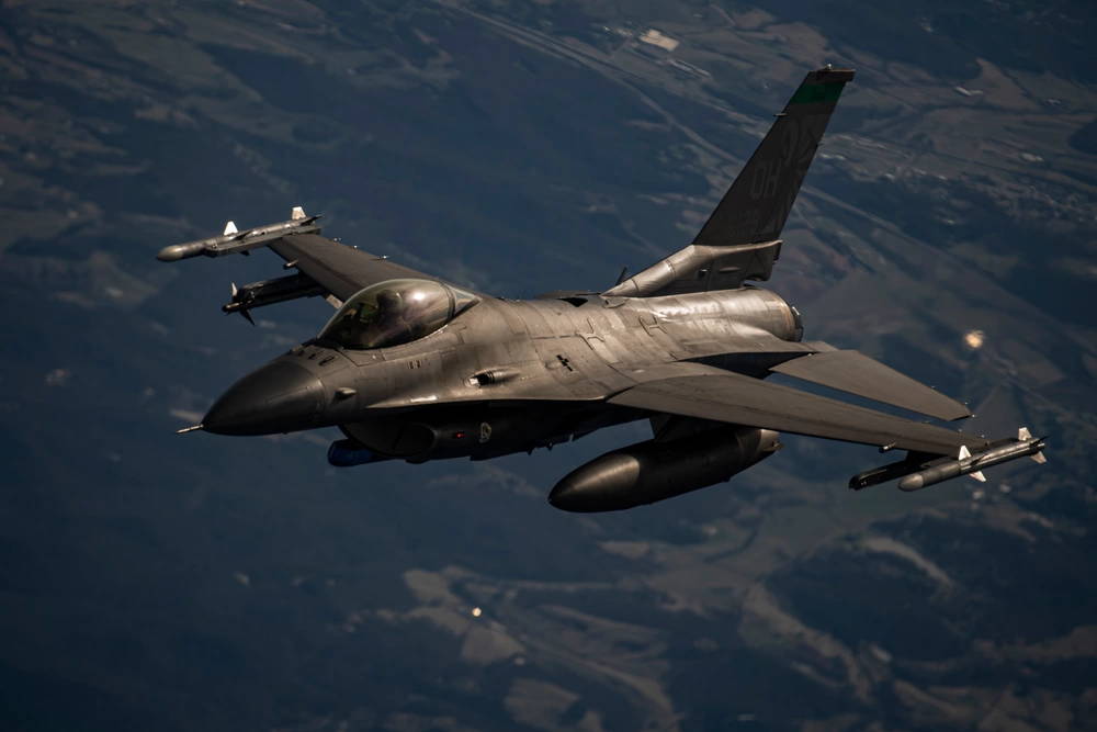 An Air National Guard Boeing General Dynamics F-16 Fighting Falcon from the 180th Fighter Wing prepares to be refueled on Jan. 12 2022, in the skys over Ohio. (U.S. Air Force Photo by Tech. Sgt. Chris Hibben)
