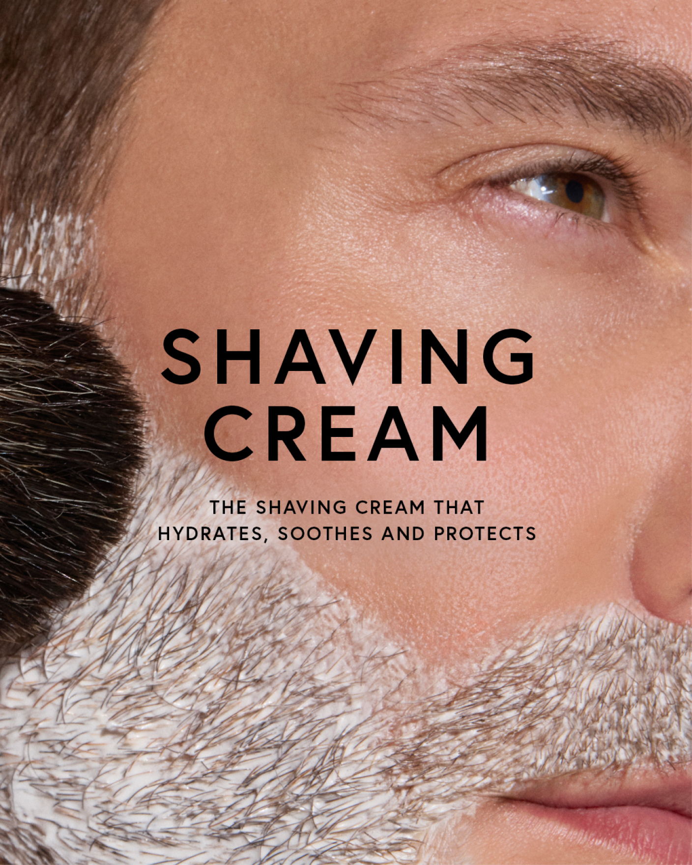Close-up of a man's face with shaving cream and text about the product.