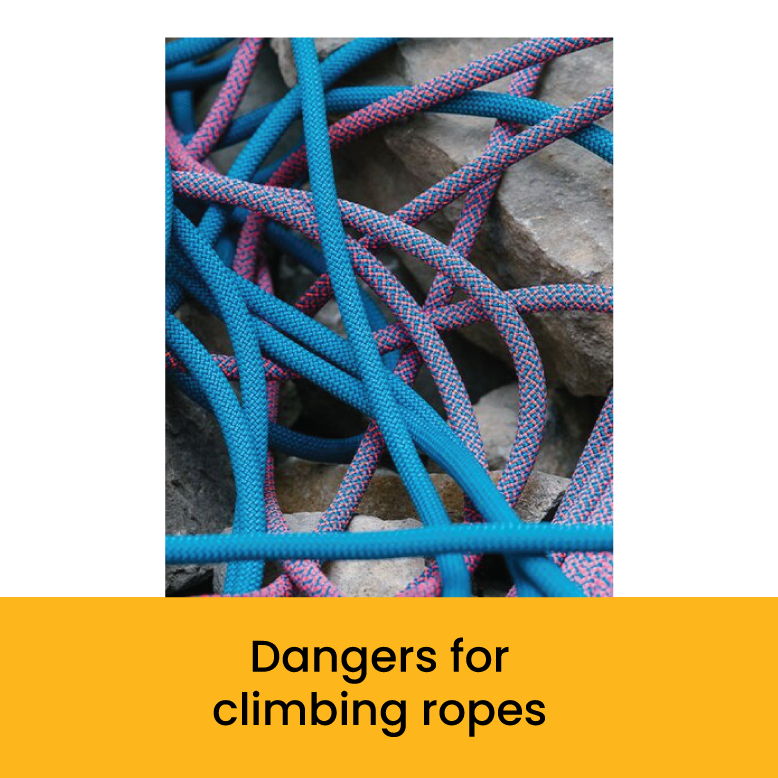 Colorful climbing ropes tangled on rocks, warning about climbing rope dangers.
