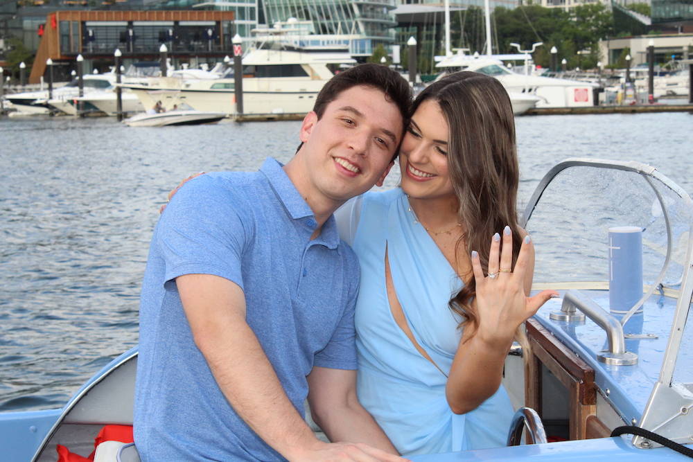 couple getting engaged on blue boat