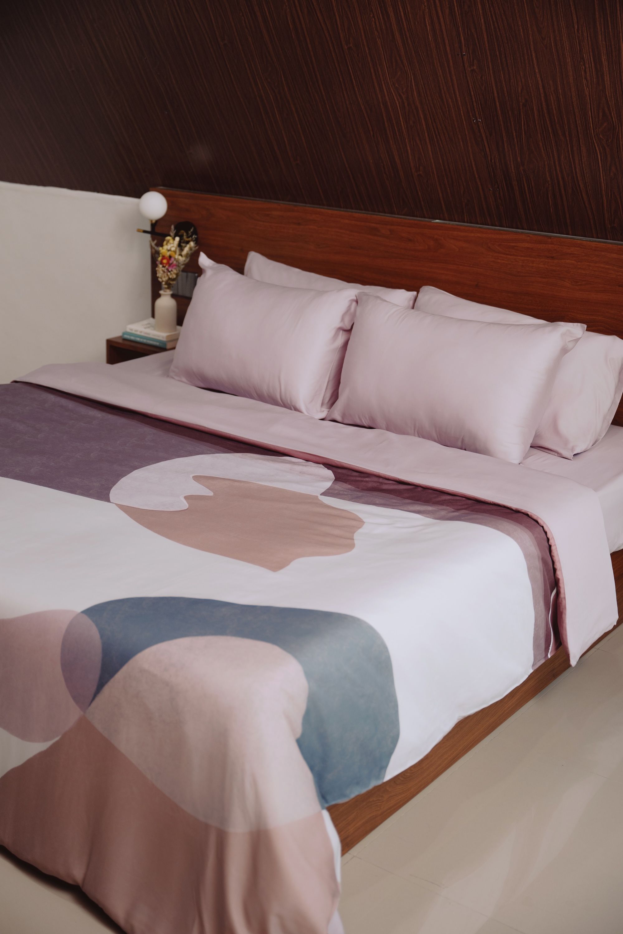 purple bedsheets with an abstract print on the duvet cover