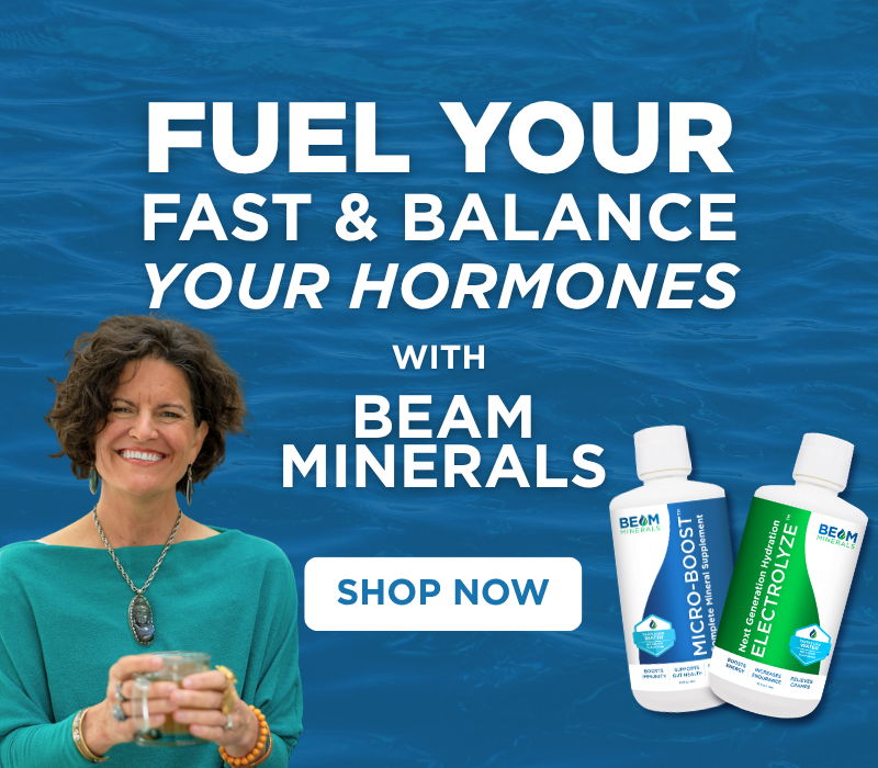 Woman holding a glass next to Beam Minerals products on a blue background.