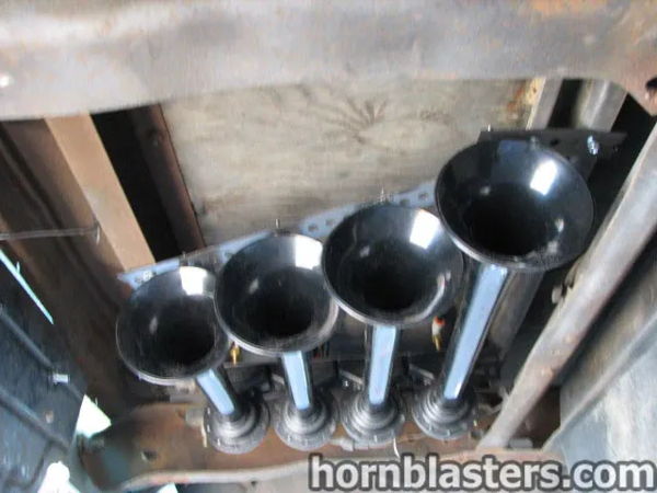 Underside close-up of the black train horn bells mounted beneath Al's 1967 Chevrolet Suburban 1500, install photo 2