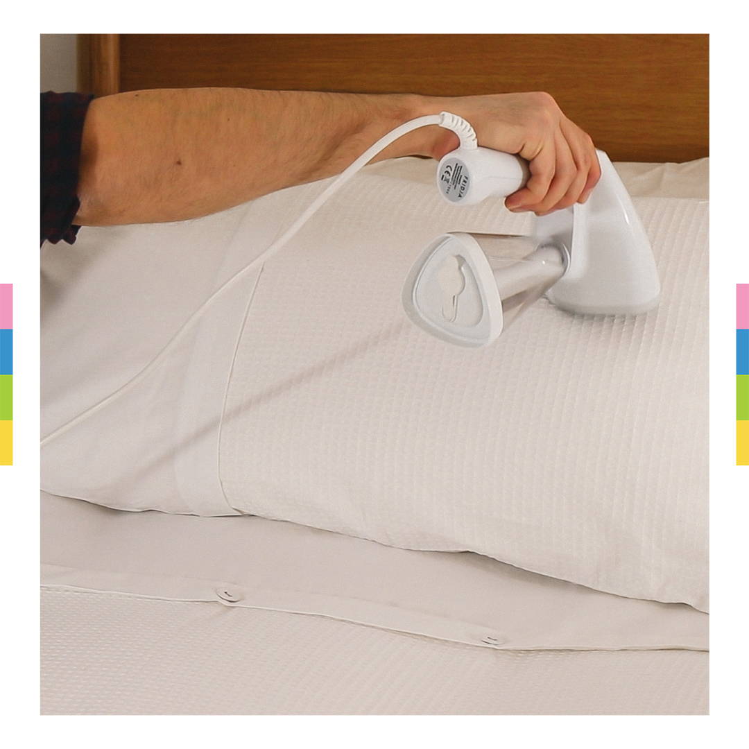 Fridja F10 Handheld Steamer ironing white sheets