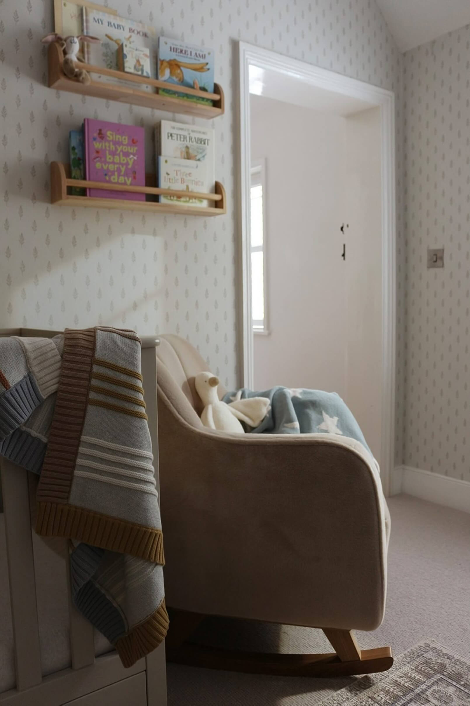 Cozy room with a rocking chair and shelves of books.