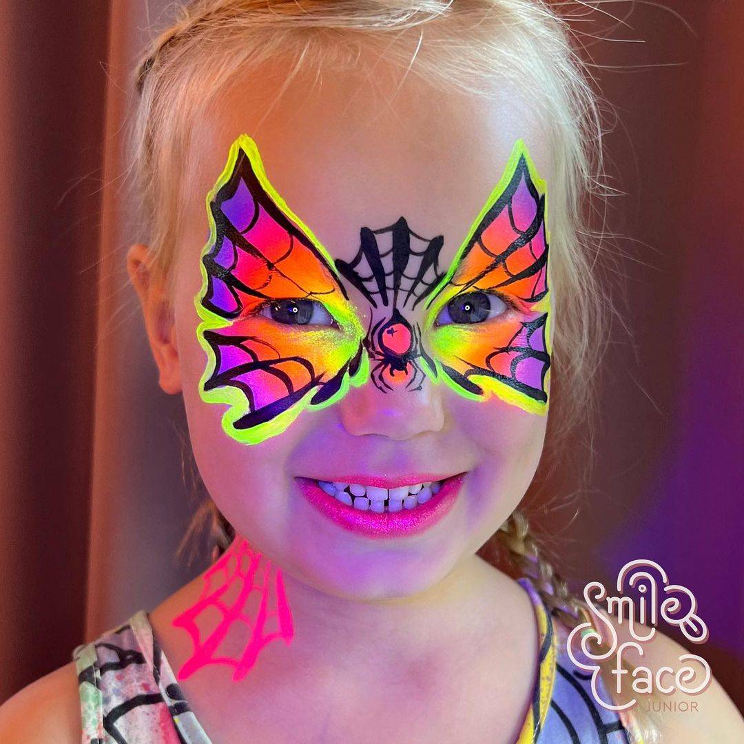 cute girl face paint spider web mask bright colours