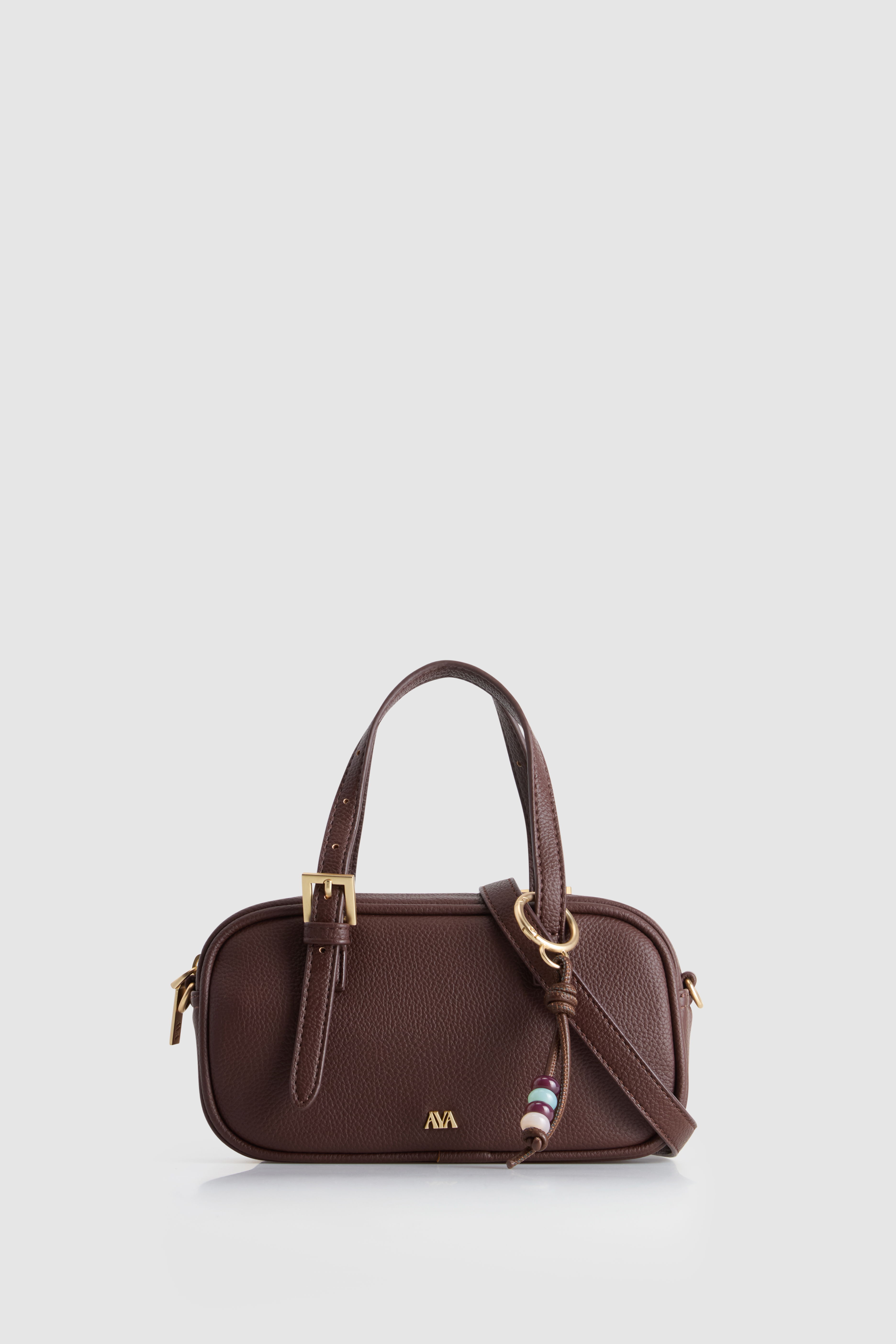 Brown handbag with gold accents and a detachable strap.