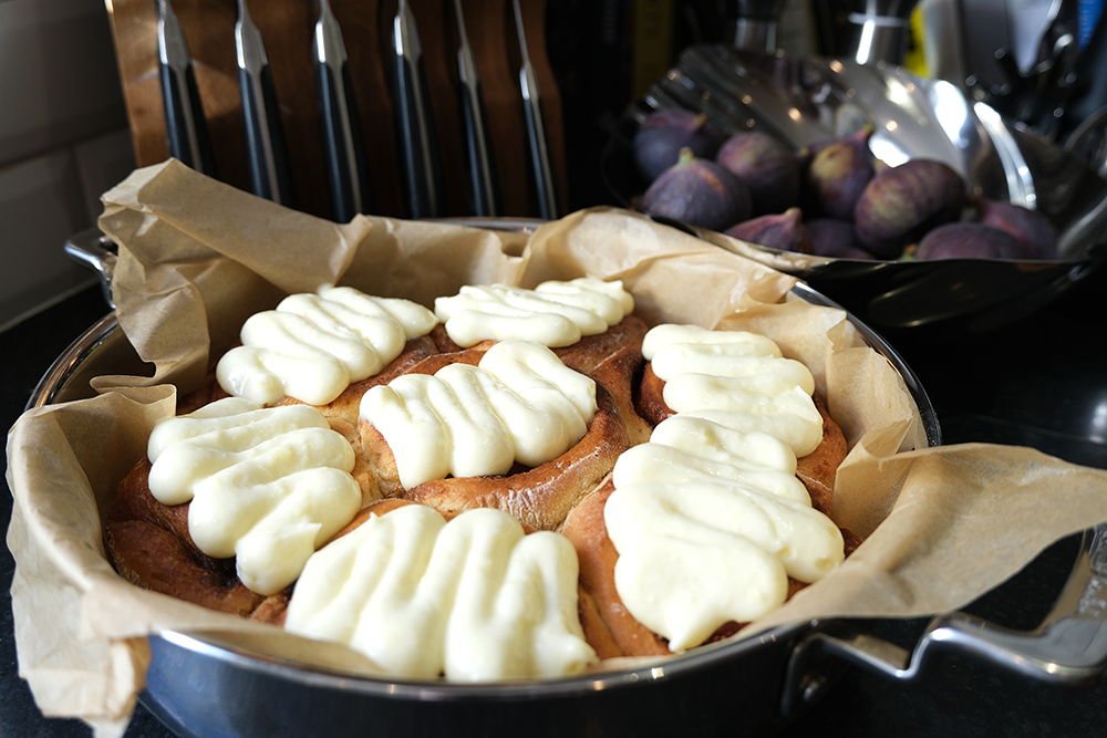 Fig and cinnamon buns topped with white icing, placed in a 316 Series Low Casserole.