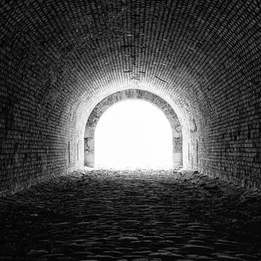 black and white moody image of a light at the end of a tunnel