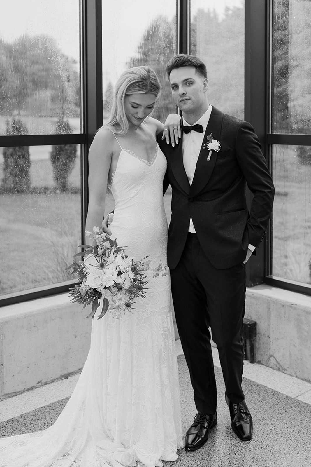 Bride and groom posing together in a stylish indoor setting.