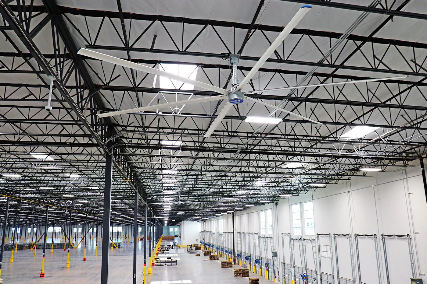 Large industrial building with high ceilings and ceiling fans.