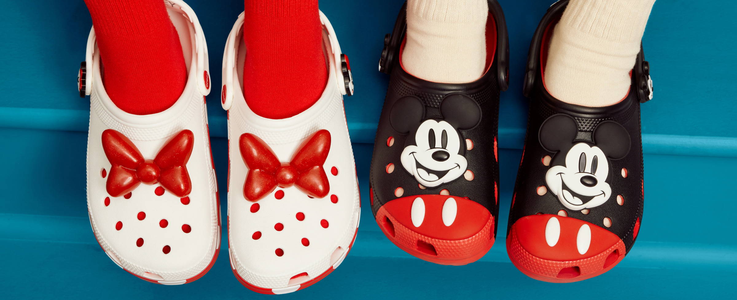 Disney Crocs featuring Minnie and Mickey Mouse designs on a blue background.