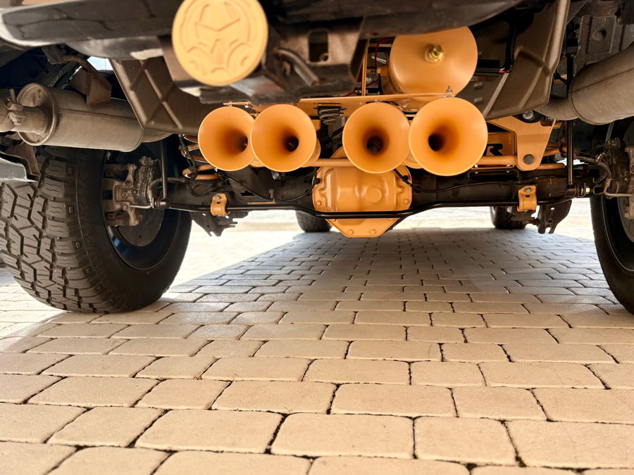 Rear undercarriage yellow train horns and air tank Conductor's Special 232 Spare Tire Delete install in spare tire well Pedro's 2021 Ram Bighorn 1500 gallery photo 4