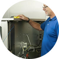 Person cleaning the top of a kitchen appliance.