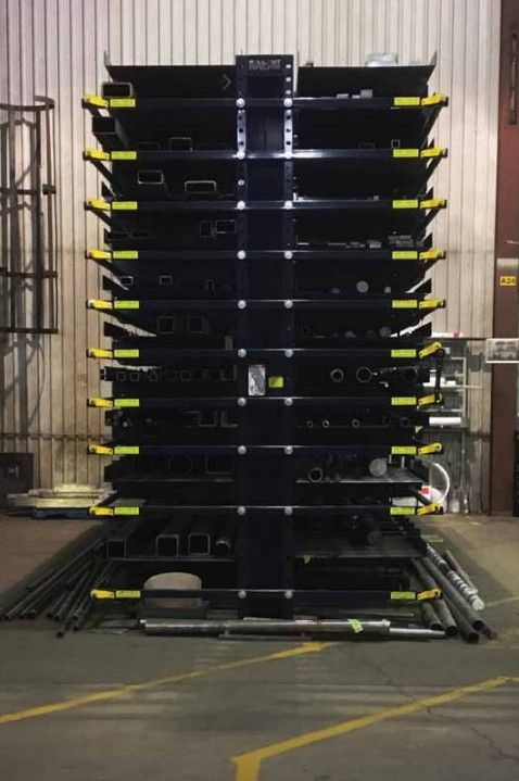 Stacked metal shelves in a warehouse, showcasing various industrial components.