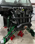 Front end on jack stands Conductor's Special train horns metallic green A-arms winch brush guard shop install Rich's Can-Am Defender 244K gallery photo 3