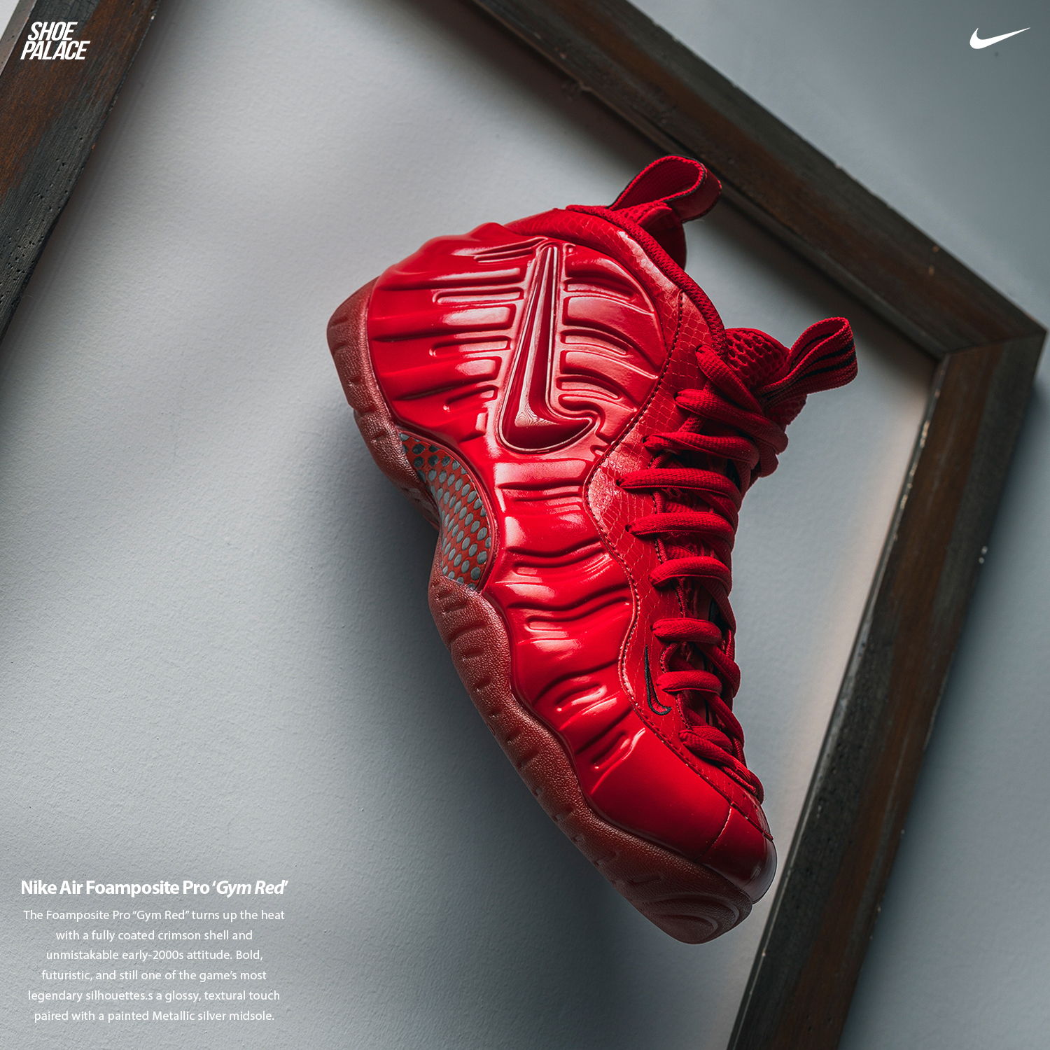 Red Nike Foamposite sneaker displayed in a frame against a neutral background.